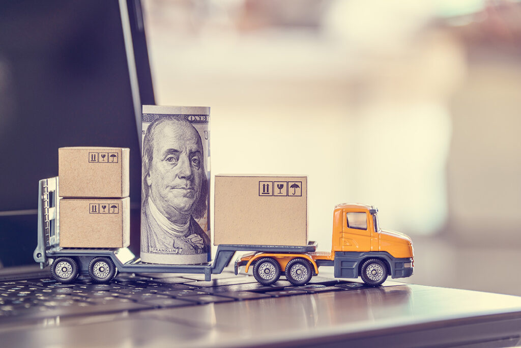 small yellow toy truck with rolled up dollar bill in center