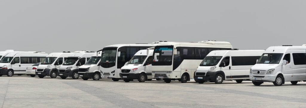 different types of white vehicles aligned in a row